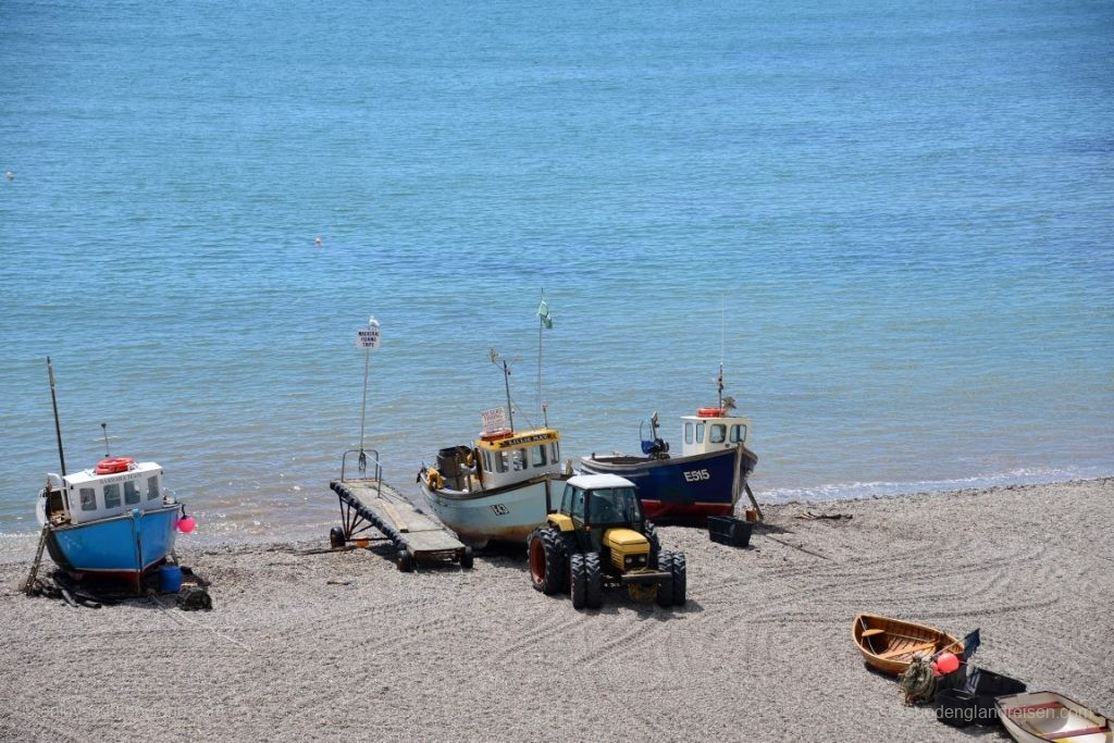 The fishermen are back with the catch of the day and the local beach tractor has pulled the boats up to the beach. They are now largely protected in the absence of a real harbour.