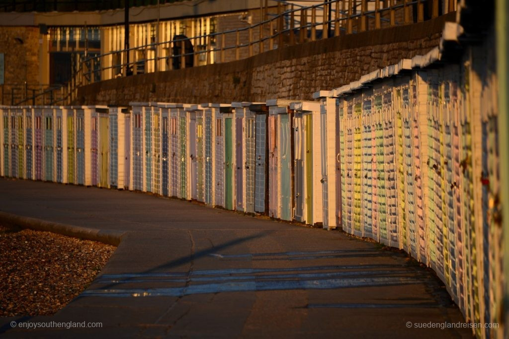 The beach huts at Lyme Regis are warming up in the first rays of sunshine on a wonderful day