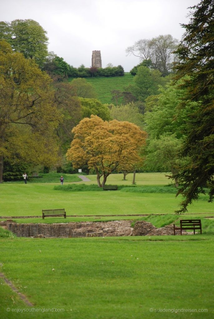 Glastonbury Tor in the background and the ruins of the Abbey in the foreground