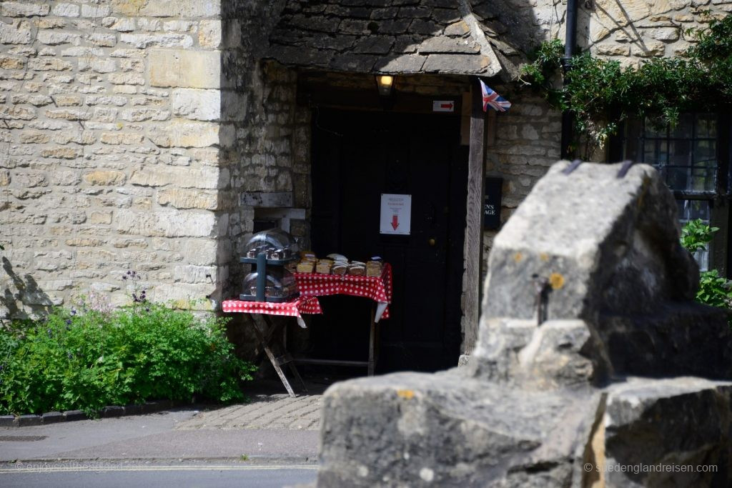 Cakes for sale at a front door in Castle Combe